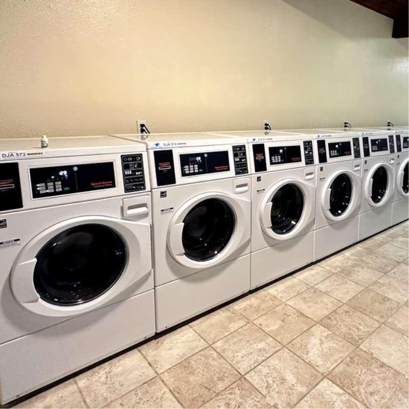 Speed Queen commercial washers in a Smart-O-Mat managed apartment laundry room